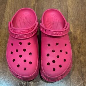 Women’s pink heeled crocs.